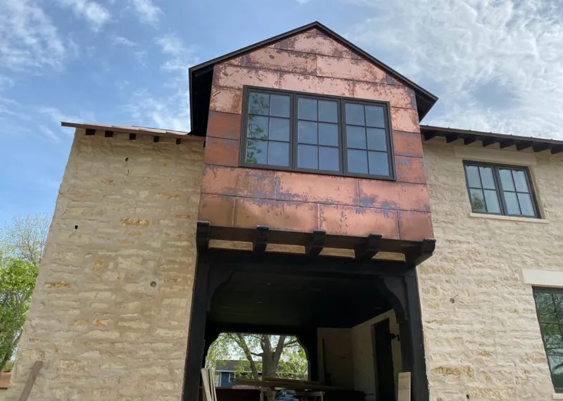 Copper metal panel facade on a stone building for Metal Roof Coating in Moberly