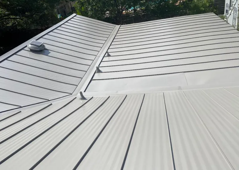 Solar attic fan installed on a metal roof for Roof Ventilation in Moberly